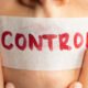 tape on woman's mouth with control written on it