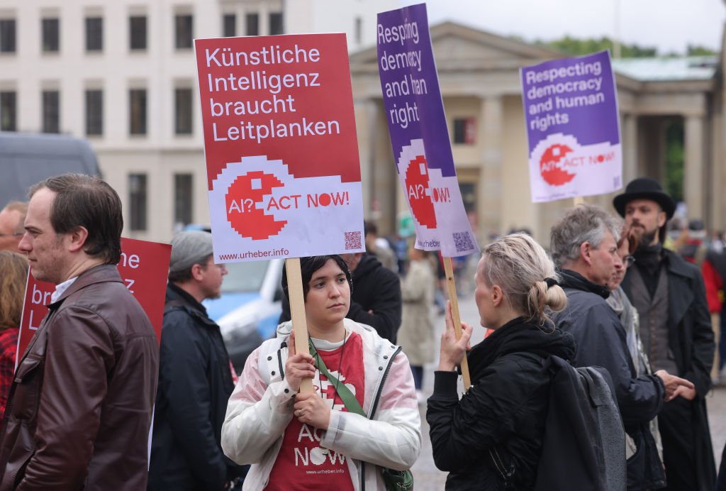 Members of the group Initiative Urheberrecht (authors' rights initiative) demonstrate to demand regulation of artificial intelligence on June 16, 2023 in Berlin, Germany. The AI regulation later adopted by the European Union is a model for many U.S. lawmakers interested in consumer protection but a cautionary tale for others who say they're interested in robust innovation, experts say. (Photo by Sean Gallup/Getty Images)