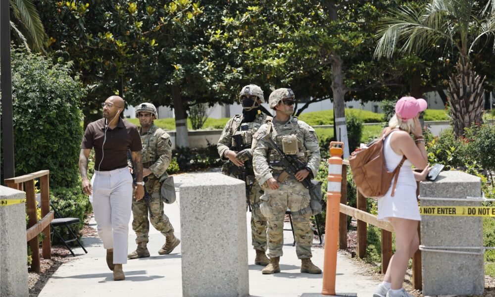 California National Guard members stand guard at an entrance to the Wilshire Federal Building on June 13, 2025 in Los Angeles, California.  (Photo by Mario Tama/Getty Images)