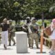 California National Guard members stand guard at an entrance to the Wilshire Federal Building on June 13, 2025 in Los Angeles, California.  (Photo by Mario Tama/Getty Images)