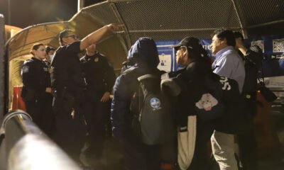 Customs and Border Protection agents question families who have presented themselves at the Paso del Norte bridge to request asylum on May 11, 2023. (Photo by Corrie Boudreaux for Source NM)